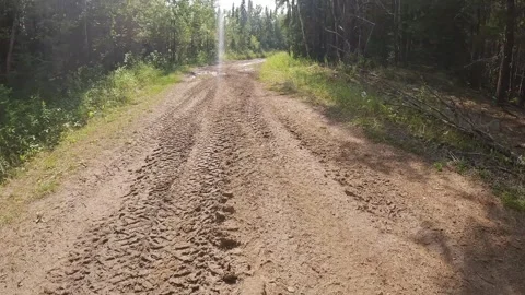 Mountain biking action camera footage while biking along a very muddy trail Stock Footage 249838312