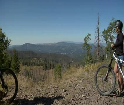 Mountain biking couple stop to rest and see view Stock Footage 21670528