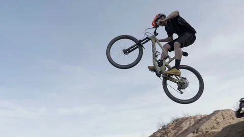 Mountain Biking Jumping Into Blue Sky in Colorado Video stock 103517659