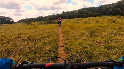 Mountain biking over a plain in Belize Stock Footage 128938009