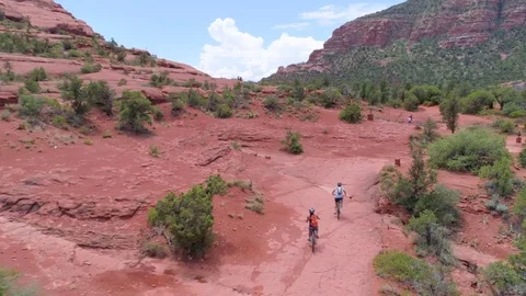 Mountain Biking over Red Rocks in Sedona by Aerial Drone Stock Footage 81157159