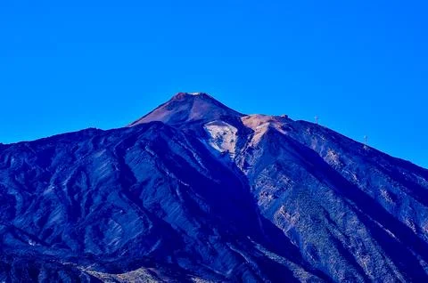 A mountain with a blue sky in the background Fotos Stock