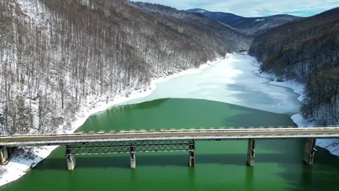 Mountain Bridge Over Emerald River During Early Spring Thaw in Snowy Valley Stock Footage 330240278