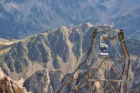 Mountain Cable car descends Stock Photos