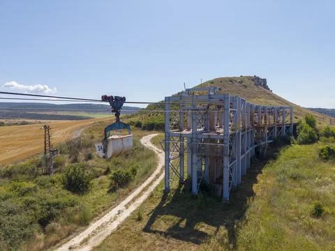 Mountain cable system near a field on a sunny day Stock Photos