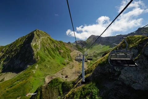 Mountain cableway stretching down over beautiful early autumn mountain landscape Stock Photos