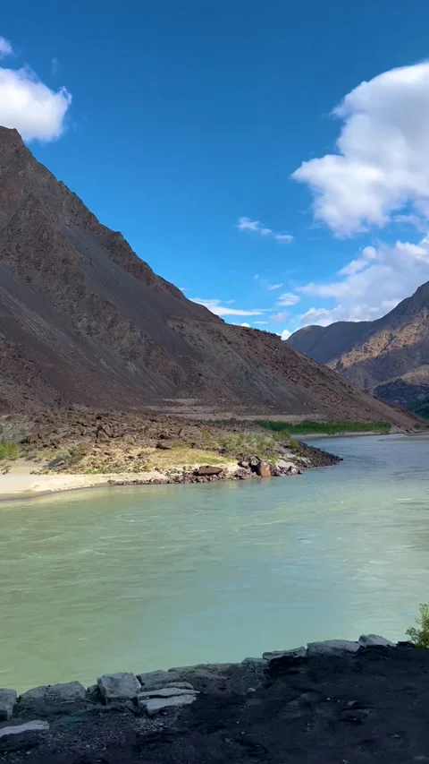 Mountain carved river basin, River Flowing Through Rugged Mountain Valley. Stock Footage 342495644