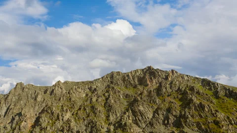 Mountain chain on the blue cloudy sky background Stock Footage 288063960