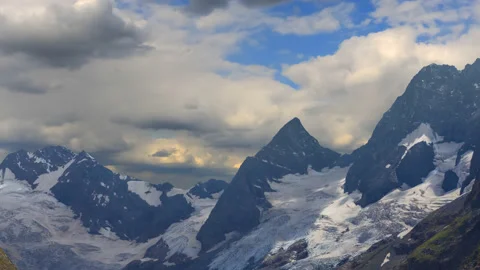 Mountain chain with glacier in snow under dense cloudy sky Stock Footage 178906698