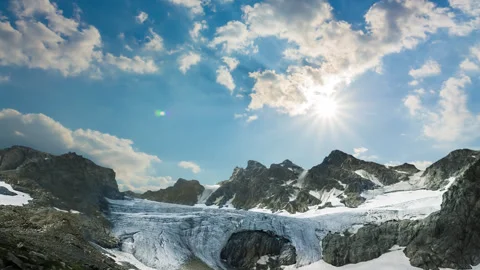 Mountain chain with glacier under a sparkle sun Video stock 342713828
