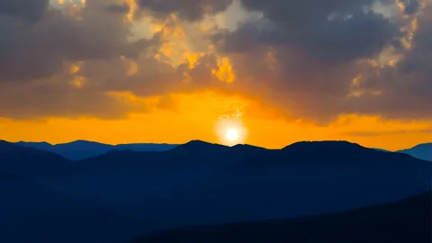Mountain chain silhouette under dramatic cloudy sky at the twilight Video stock 201129842