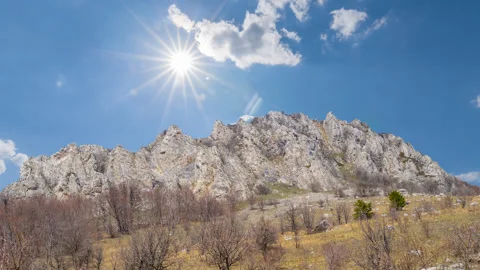 Mountain chain under a sparkle sun Stock Footage 253982793