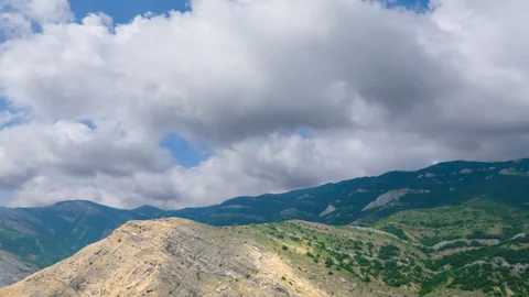 Mountain chains under a dense cloudy sky Video stock 329179530