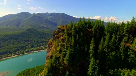 Mountain cliff by a blue lake Stock Footage 53307724