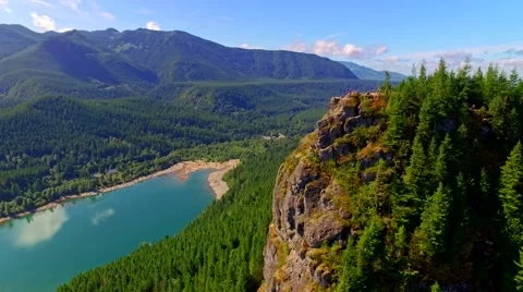 Mountain cliff by a blue lake Stock Footage 53308005