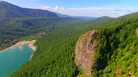 Mountain cliff by a blue lake Stock Footage 53308236