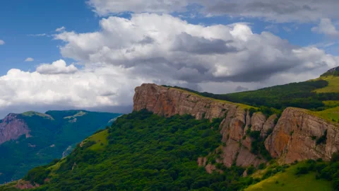 Mountain cliff on dense cloudy sky background Stock-Footage 256082882