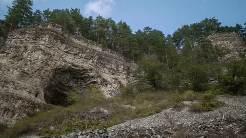 Mountain cliff overgrown with forest. Blue sky. Moving clouds. Panorama. Ancient Stock Footage 74010777