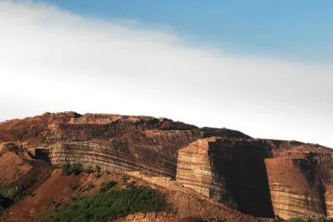 Mountain cliff of red brown colored chinese soil agriculture landscape. Stock Photos