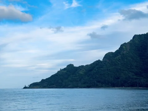 Mountain Cliffs tower over the shores of Hawaii coastline Stock Footage 319362263