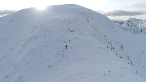 Mountain Climber Almost at the Summit of a Snowy Mountain Stock Footage 84739188