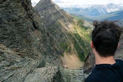 Mountain climber on the edge of a cliff Stock Photos