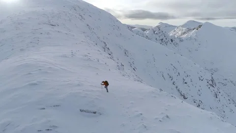 Mountain Climber on the Final Ascent of a Snowy Mountain Stock Footage 84740304