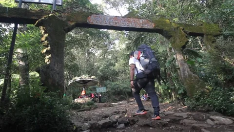 MOUNTAIN CLIMBER AT GATE OF GEDE PANGRANGO MOUNTAIN IN WEST JAVA, INDONESIA Stock Footage 163918504