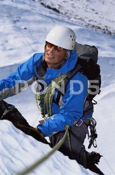 Mountain climber going up snowy mountain (selective focus) Stock Photos