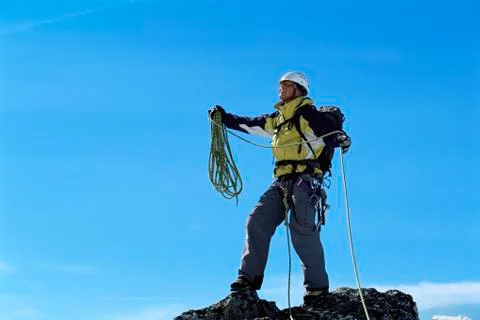 Mountain climber standing on top of mountain (selective focus) Stock Photos