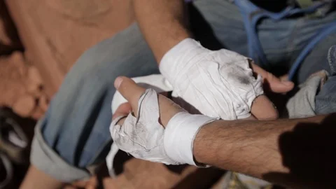 Mountain climber wraps hands in tape Indian Creek Utah Stock Footage 90962476