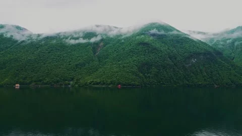 A mountain in the clouds. A mountain in the water. Clouds. White clouds Stock Footage 263442397