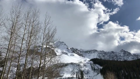 Mountain Clouds Sun Snow Pine Tree Stock Footage 153617445