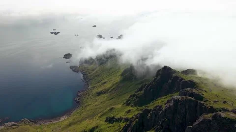 Mountain coastline beneath low clouds above the ocean Stock-Footage 341328859