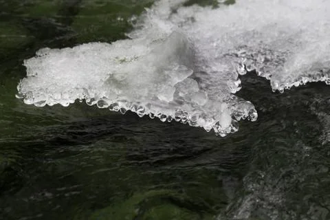Mountain cold stream and figured ice crust in winter Stock Photos