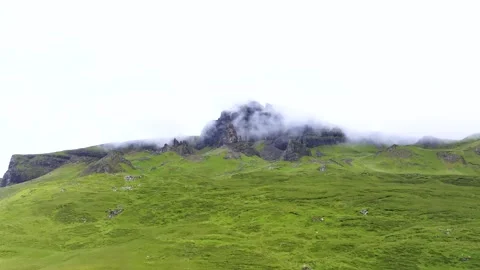 A mountain covered in green grass and fog Stock Footage 306561594