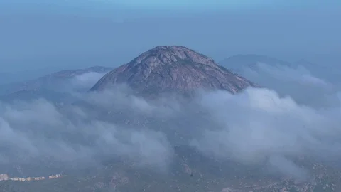 Mountain covered by thick layers of passing clouds. 動画素材 90942364