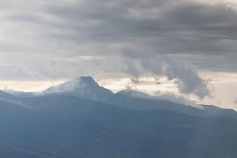 Mountain covered by white clouds Stock Photos