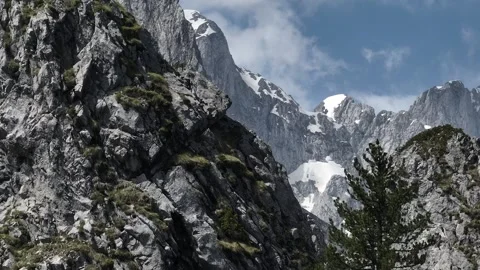 Mountain crests and slope with a snow, sunny summer day. aerial view Stock Footage 251998031