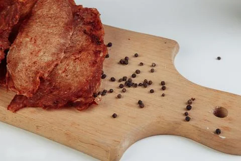Mountain of cured meat with spices on a table Stock Photos