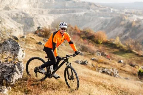 Mountain cyclist riding single track in valley Stock Photos