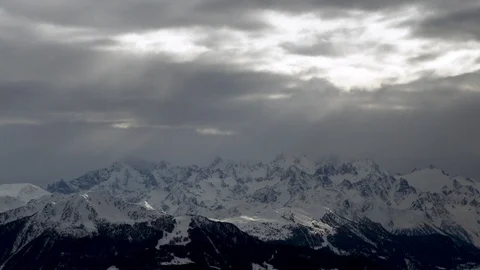 Mountain in deep snow with dramatic cloudy sky during day time Stock Footage 121579235
