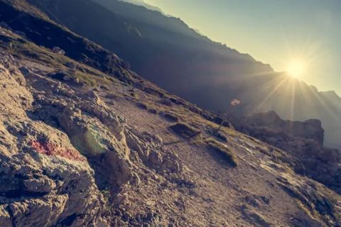 Mountain direction sign light by setting sun. Stock Photos