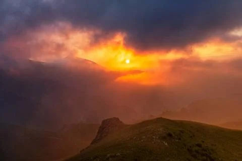 Mountain dramatic sunset in clouds Beautiful mountain landscape with drama... Stock Photos