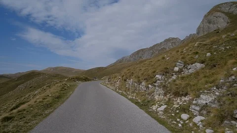 Mountain Drive. POV from the drivers perspective through a winding mountain road Stock Footage 98313171