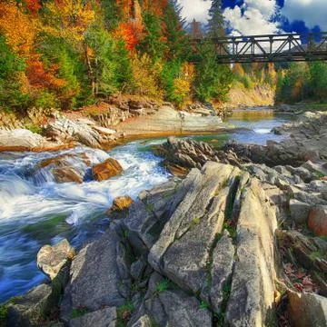 Mountain fast flowing river stream of water in the rocks at autumn Stock Photos