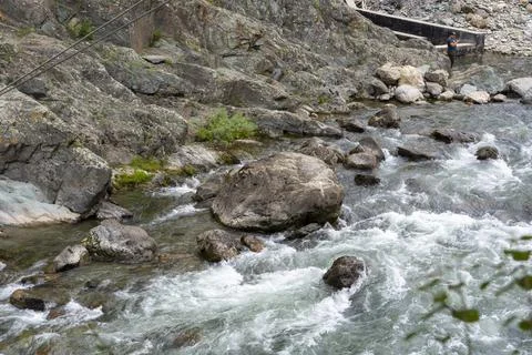 Mountain fast river flows in a stone bed Stock Photos