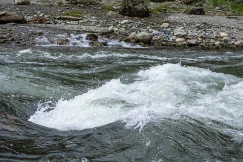 Mountain fast river flows in a stone bed Stock Photos