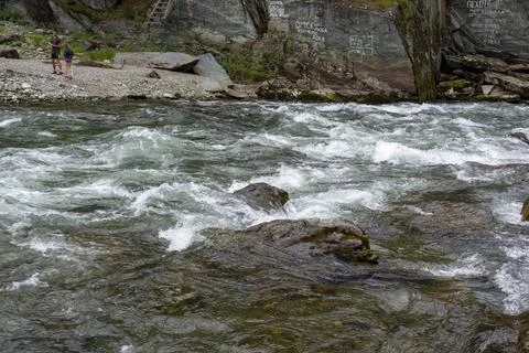Mountain fast river flows in a stone bed Stock Photos