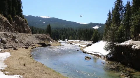 Mountain fast river with helicopter passing by Stock Footage 49510989